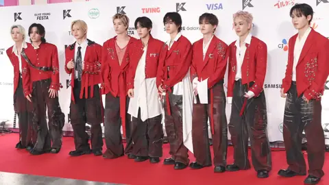 Nine members of JO1 standing on a red carpet in front of a backdrop of KCON Japan 2026
