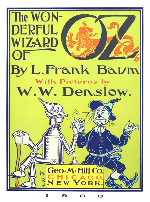 Cover of the 1900 novel "The Wonderful Wizard of Oz" by L. Frank Baum, illustrated by W. W. Denslow, showing the Tin Woodman and the Scarecrow on a bright yellow and green background.