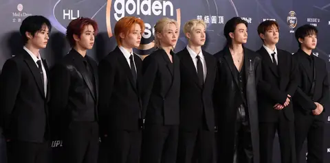 The eight members of Stray Kids, looking forward.